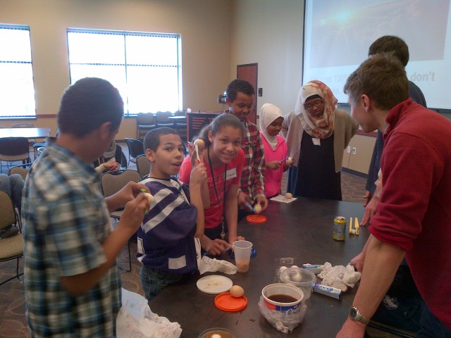 Medical scholars brushing stained "teeth" (eggs!)